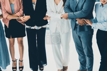 Photo for Business people holding hands together showing partnership, collaboration, trust, teamwork and support. uds - Royalty Free Image