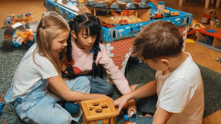 Photo for Top view of multicultural smart students playing wooden block together at playroom of kindergarten. Diverse children play toy to improve creativity and imaginary. Creative activity concept. Erudition. - Royalty Free Image