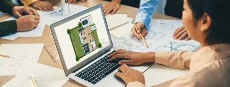 Photo for Professional architect decide the blueprint for eco-friendly house during discussion about changing blueprint plan at meeting table with architectural document scatter around. Closeup. Delineation - Royalty Free Image