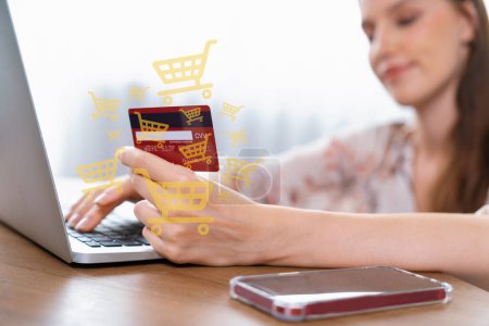 Photo for Elegant customer wearing floral shirt holding credit card typing laptop choosing online platform. Smart consumer opening e-commerce application using cashless technology shopping inventory. Cybercash. - Royalty Free Image