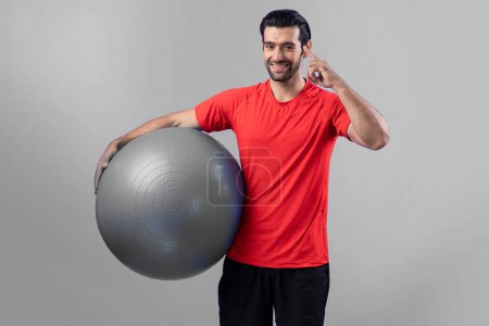 Photo for Full body length gaiety shot athletic and sporty young man with fitness exercising ball in standing posture on isolated background. Healthy active and body care lifestyle. - Royalty Free Image