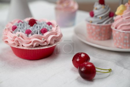 Photo for Presentation piece of cupcake on white standing cake with tea pot set in concept of pastel colors special cuisine. Content creative of social media with favorite sweets bakery dish. Tastemaker. - Royalty Free Image