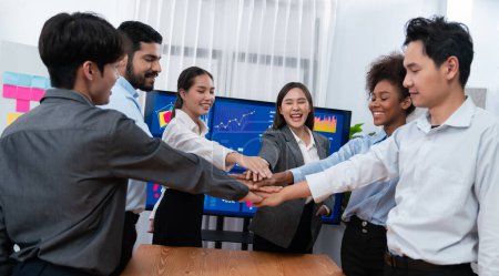 Photo for Multiracial office workers hand stack shows solidarity, teamwork and trust in diverse community. Businesspeople unite for business success through synergy and collaboration by hand stacking. Concord - Royalty Free Image