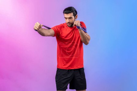 Photo for Full body length gaiety shot athletic and sporty young man with fitness elastic resistance band in standing posture on isolated background. Healthy active and body care lifestyle. - Royalty Free Image