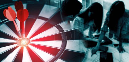 Photo for Business Target Goal For Success Strategy Concept - Red dart arrow hitting center goal on dart board with business people working in background showing precision and success of business target. uds - Royalty Free Image