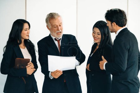 Photo for Senior caucasian manager working in office with assistance of young Asian business people and translator in meeting. Corporate international business and secretary language translation concept. uds - Royalty Free Image