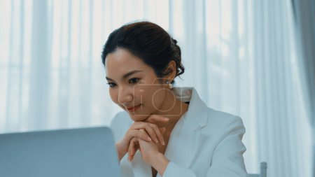Photo for Young businesswoman sitting on the workspace desk using laptop computer for internet online content writing or secretary remote working from home. Vivancy - Royalty Free Image