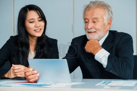 Photo for Senior executive manager and young businesswoman working in meeting room in the office. The woman is secretary or translator. International business language translation concept. uds - Royalty Free Image