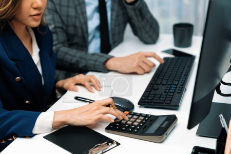 Photo for Cropped hands businessman with coworker calculating with calculator manuals financial and accounting report on computer database annual asset report, analyzing expenses and revenue company. Infobahn. - Royalty Free Image
