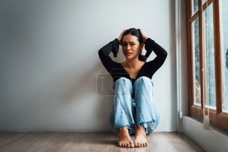 Photo for Depressed young Asian woman with mental health problem in mind need uttermost treatment from overthinking fatigue, disruptive thought, dissocial, anxiety and other mental health disorders . - Royalty Free Image