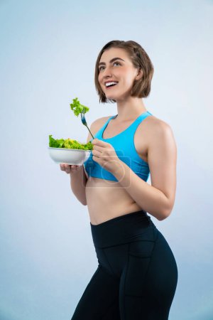 Photo for Full body length gaiety shot athletic and sporty young woman with healthy vegan food in standing posture on isolated background. Healthy active and body care by vegetarian lifestyle. - Royalty Free Image
