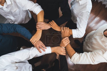Photo for Business team joining hand in circular together symbolize successful group of business partnership and strong collective unity teamwork in community workplace. Prudent - Royalty Free Image