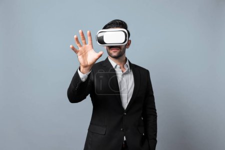 Photo for Professional smart business man holding something while wearing VR glasses. Caucasian project manager with virtual reality goggles while present technology innovation with white background. Deviation. - Royalty Free Image