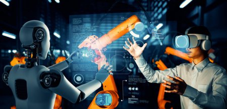 Téléchargez les photos : XAI Robot industriel mécanisé et travailleur humain travaillant ensemble dans la future usine. Concept d'intelligence artificielle pour la révolution industrielle et l'automatisation des processus de fabrication. - en image libre de droit