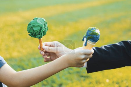 Photo for Businessman exchange tree to a boy holding melting Earth as part of ESG and CSR initiative concept of corporate responsibility for greener environment and sustainable future generation. Gyre - Royalty Free Image