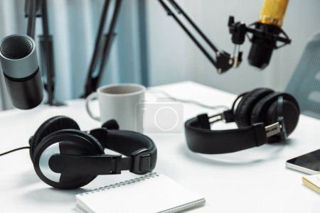 Photo for Modern office studio equipment microphone setting, laptop, tablet and headphone prepared with coffee on live streaming with empty host channel steamer podcast social media online concept. Postulate. - Royalty Free Image