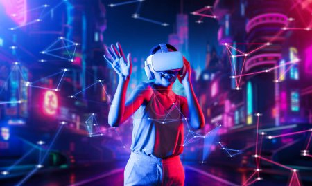 Photo for Female standing in virtual reality cyberpunk style building wear VR headset connecting metaverse, future cyberspace community technology, Woman dancing raising one arm holding goggle. Hallucination. - Royalty Free Image