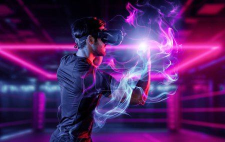 Photo for Man wearing VR glass and smashing or punching at camera in neon boxing arena. Sport gamer boxing and moving gesture in metaverse or virtual world while using digital technology innovation. Deviation. - Royalty Free Image