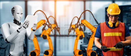 Téléchargez les photos : MLB Robot industriel mécanisé et travailleur humain travaillant ensemble dans la future usine. Concept d'intelligence artificielle pour la révolution industrielle et l'automatisation des processus de fabrication. - en image libre de droit