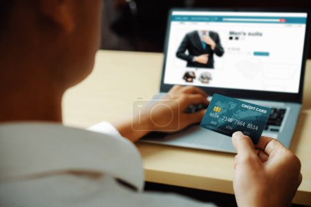Photo for Young man use credit card for shopping payment online on laptop computer application or website. E-commerce and online shopping concept. uds - Royalty Free Image
