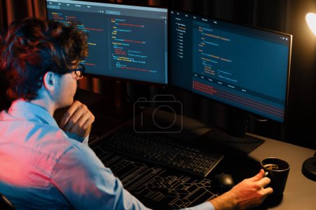 Photo for Working IT developer concentrating online software while drinking coffee on surrounded by coding application pc screens, creating program for firmware on website at neon modern office home. Gusher. - Royalty Free Image