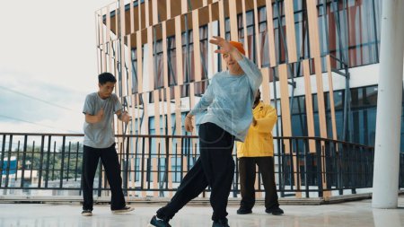 Hip hop team dance break dance while multicultural friend surrounded and clapping hands to cheer or encourage his friend to dance. Active and energetic street dance. Outdoor sport 2024. Endeavor.