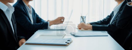 Photo for Two business executive in boardroom discuss term and company merging agreement, review corporate contract document as business partnership and cooperation with acquisition and merger concept. Shrewd - Royalty Free Image
