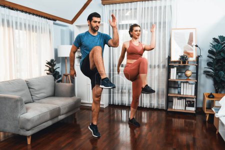Athletic and sporty fitness couple or exercise buddy running posture at home body workout exercise session for fit physique and healthy sport lifestyle at home. Gaiety home exercise workout training.