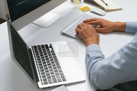 Photo for Cropped image of hands IT developer working online software information on pc and laptop with typing coding program on application project. Technical engineer writing crucial memo lists. Pecuniary. - Royalty Free Image