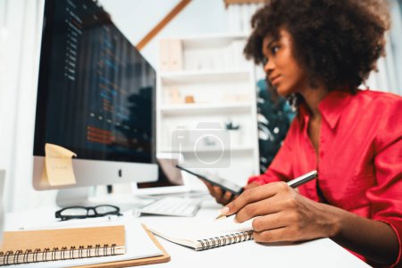 Photo for Young working African woman creating coding website developer, thinking data information designer at home office, focusing on laptop Concept of analytical data center in java project job. Tastemaker. - Royalty Free Image