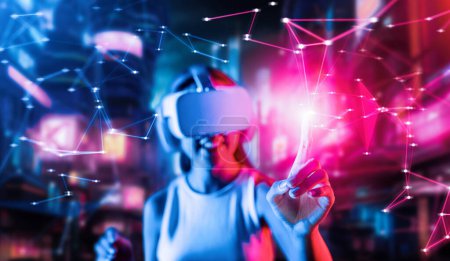 Téléchargez les photos : Blur of smart female stand in cyberpunk style building in meta wear VR headset connecting metaverse, future cyberspace community technology, Woman use index finger touch virtual object. Hallucination. - en image libre de droit