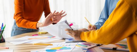 Photo for Startup company employee working together, analyzing BI dashboard paper on financial data report and planning strategic marketing for business success in panorama banner. Synergic - Royalty Free Image