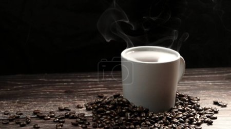 Photo for Top view of coffee or espresso with piles of coffee beans. Close up of fresh roasted coffee bean scatter around wooden table with cup of americano and aromatic stream and smoke from seed. Comestible. - Royalty Free Image