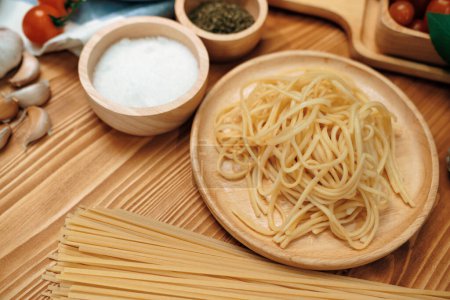 Photo for Health foods recipe ingredients of special menu homemade cooking raw spaghetti with tomato sauce and basil of macro photo shooting placing elements on preparing wooden blurred background. Postulate. - Royalty Free Image