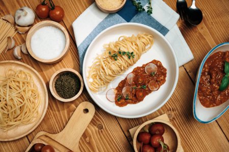 Photo for Delicious foods special menu homemade preparing station spaghetti with minced meat top tomato sauce and basil shooting placing elements serving with chef table surround decorative spices. Postulate. - Royalty Free Image