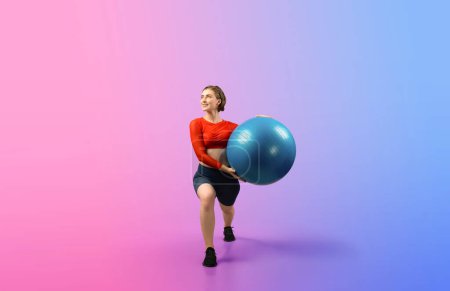 Photo for Full body length gaiety shot athletic and sporty young woman with fitness exercising ball in standing posture on isolated background. Healthy active and body care lifestyle. - Royalty Free Image