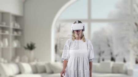 Photo for Excited girl wearing VR living room to connect metaverse surround fantasy mountain ice with stream water magical world fairytale forest wonderland with snowfall fantastic dreamy winter. Contraption. - Royalty Free Image