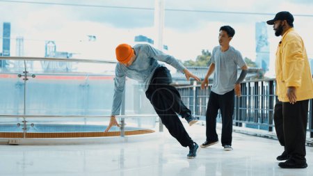 Photo for Hipster perform break dance while friend encourage him at mall. Diverse or multicultural street dancer clapping hands while watching young dance practice street dance. Outdoor sport 2024. Endeavor. - Royalty Free Image