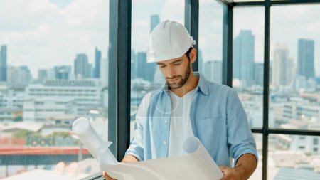 Photo for Professional architect engineer or male worker in casual outfit looking at skyscraper and city view while holding project plan. Creative design, civil engineering, building construction. Tracery - Royalty Free Image
