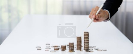 Photo for Growth coin stack symbolizing business investment and economic growth. Business people doing financial planning to achieve financial goal and contribute maximum profit gain . Shrewd - Royalty Free Image