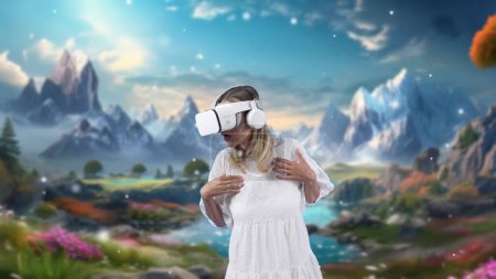 Photo for Excited smiling woman looking around by VR in fairytale forest mountain rock ice wonderland snowfall landscape getting fresh air in meta magical world fantasy jungle creativity in winter. Contraption. - Royalty Free Image