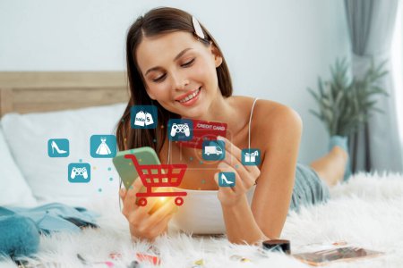 Photo for Customer lying down wearing white tank top holding credit card typing phone choose online platform. Smart consumer opening e-commerce application use cashless technology shopping inventory. Cybercash. - Royalty Free Image