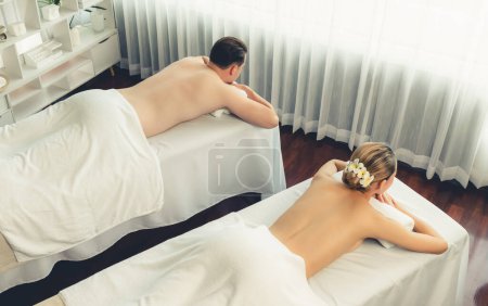 Photo for Top view caucasian couple customer enjoying relaxing anti-stress spa massage and pampering with beauty skin recreation leisure in day light ambient salon spa at luxury resort or hotel. Quiescent - Royalty Free Image