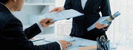 Photo for Corporate accountant team use calculator to calculate and maximize tax refunds and improve financial performance based on financial data report. Modern business accounting in panorama. Shrewd - Royalty Free Image